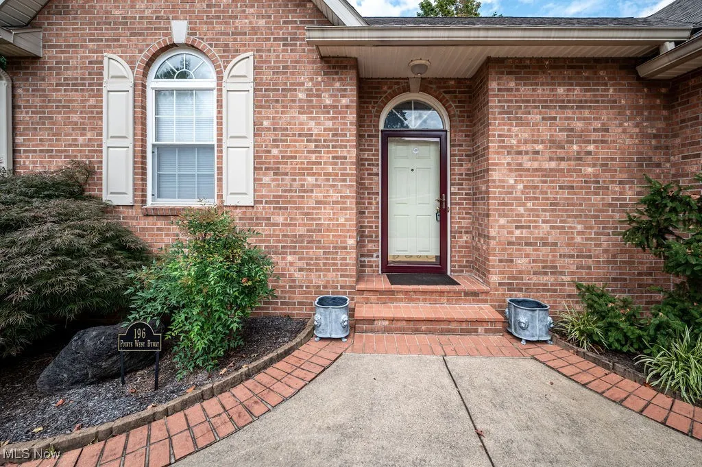Entrance to property with brick siding