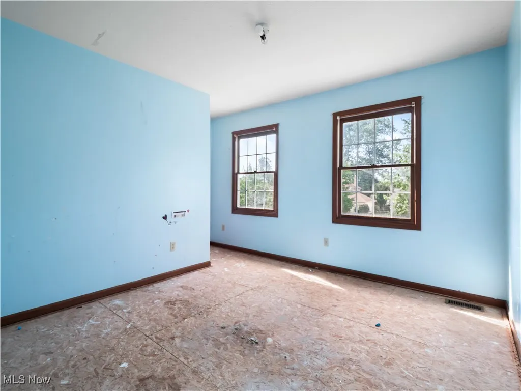 Unfurnished room with baseboards