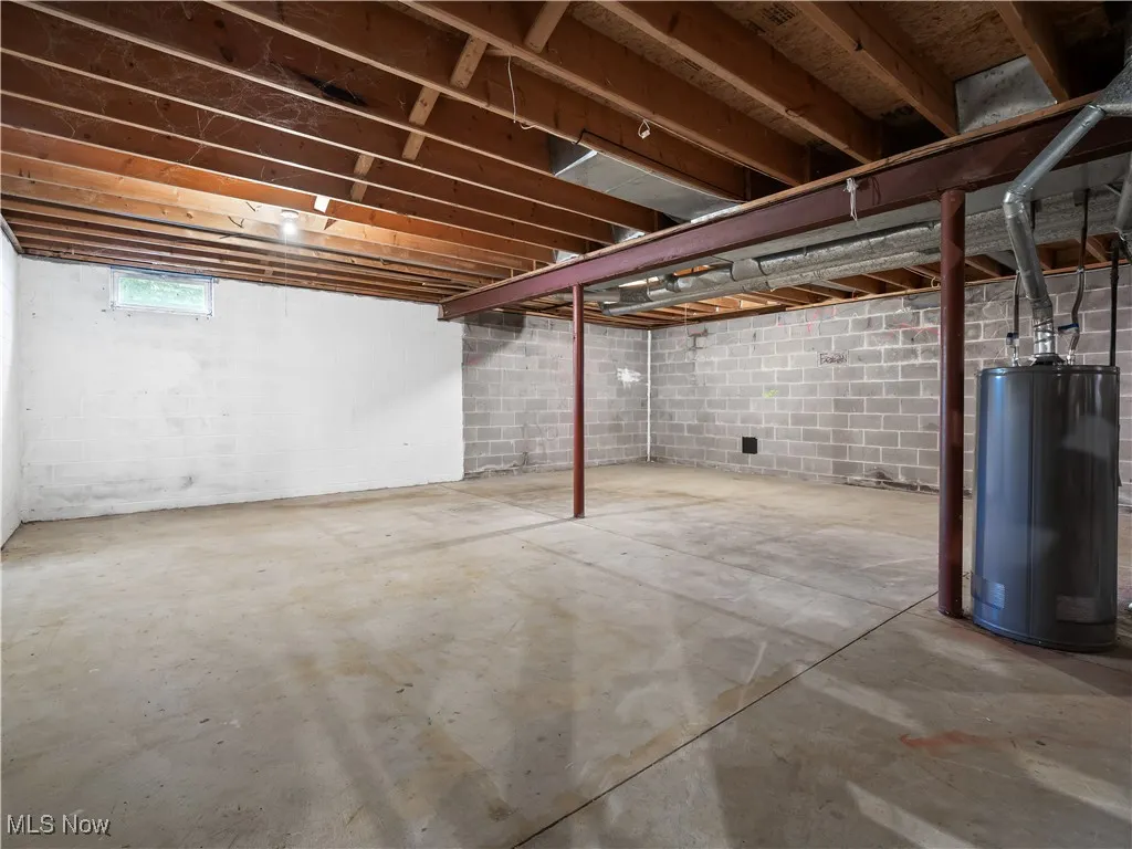 Below grade area featuring hot water tank