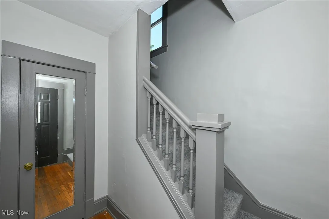 Stairway featuring hardwood / wood-style flooring and baseboards