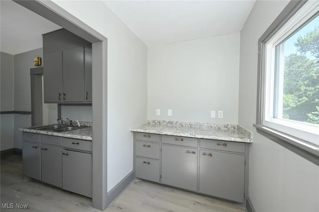 Full bathroom with plenty of natural light, light wood finished floors, and vanity