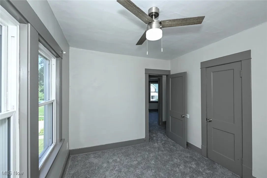 Unfurnished bedroom with carpet floors and ceiling fan