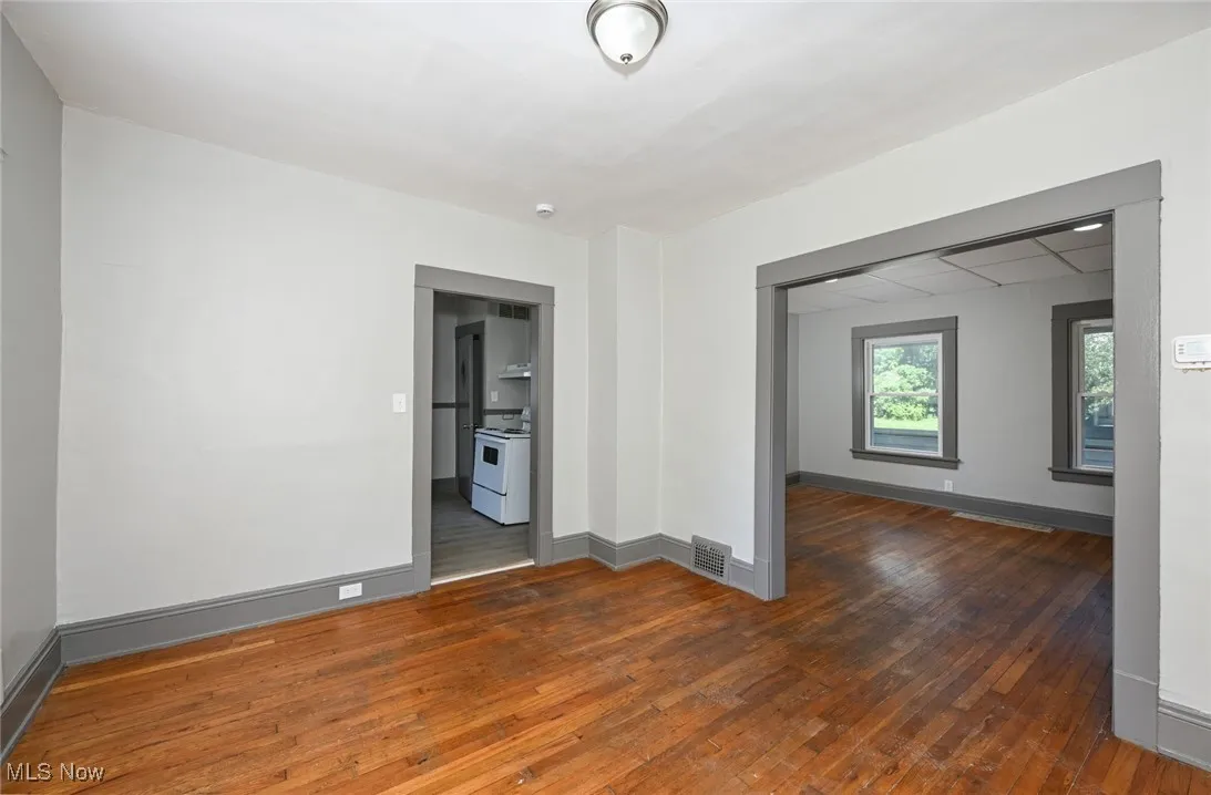 Empty room featuring hardwood / wood-style floors and baseboards