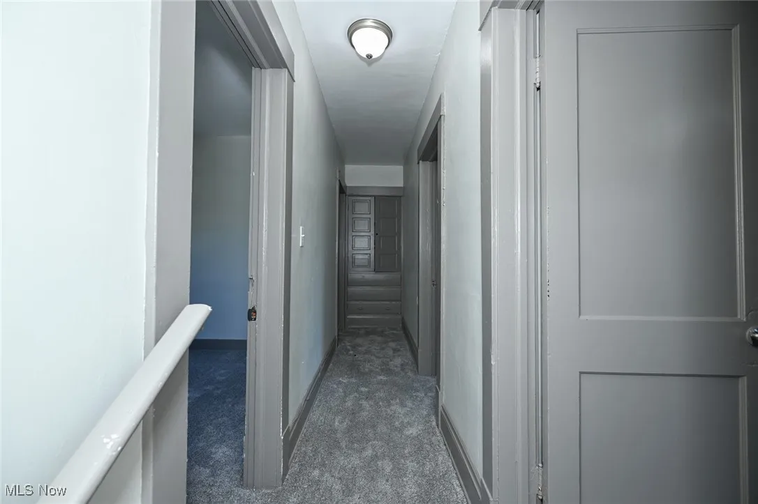 Hall featuring dark carpet