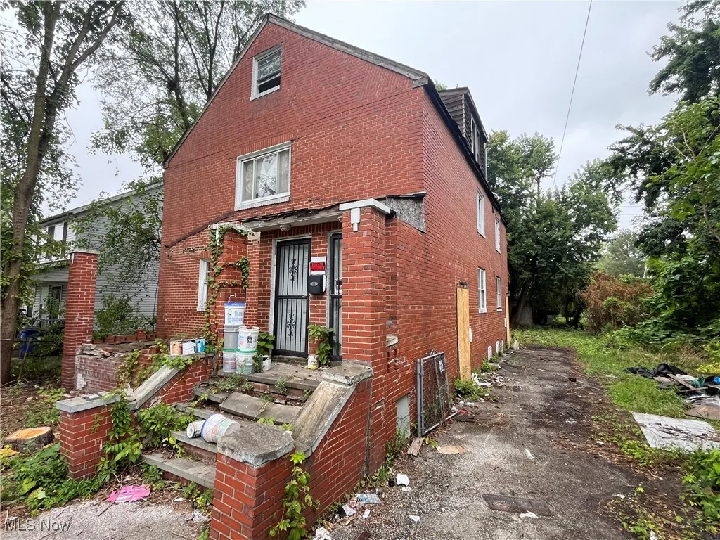 View of front of home featuring brick siding and driveway