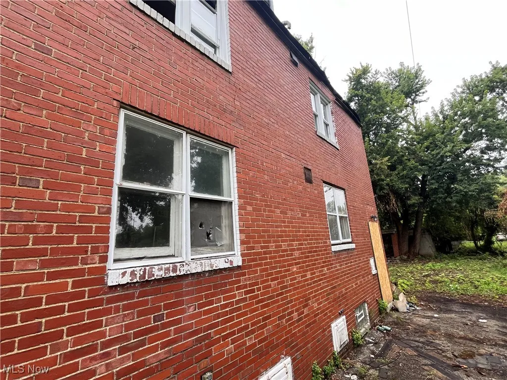 View of side of property featuring brick siding
