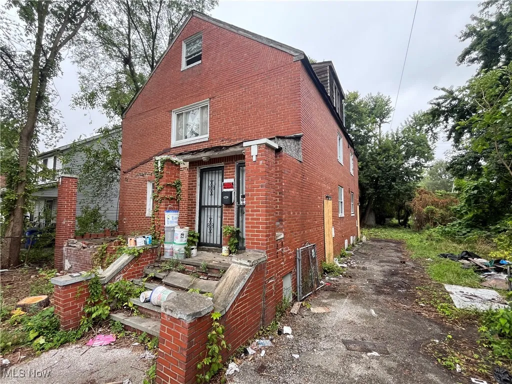 View of front facade featuring brick siding and driveway