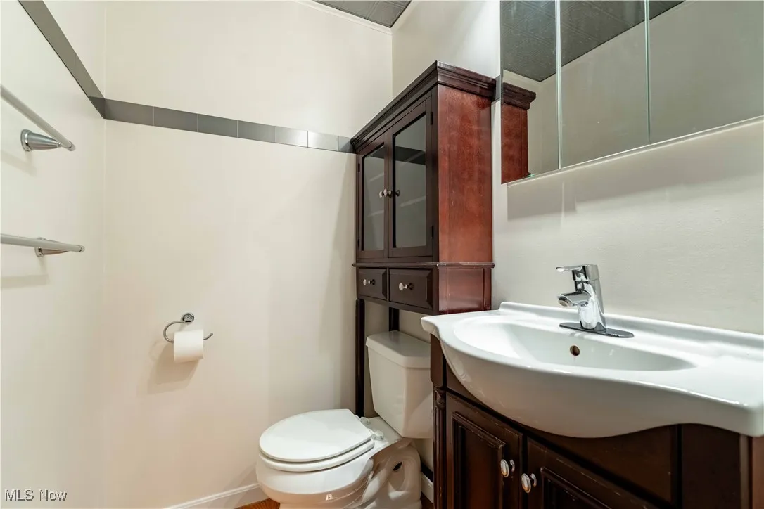 Half bath featuring vanity and toilet
