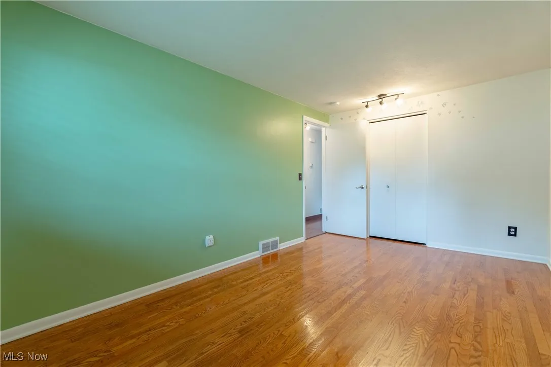 Empty room with wood finished floors and baseboards