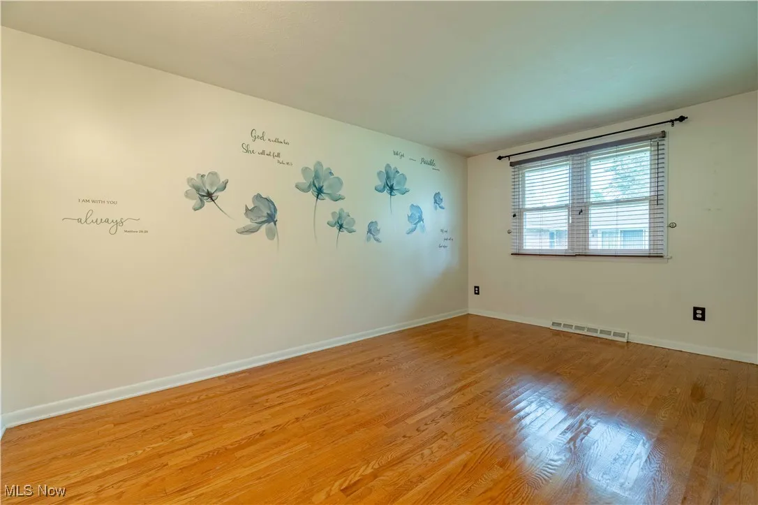 Empty room with light wood finished floors and baseboards