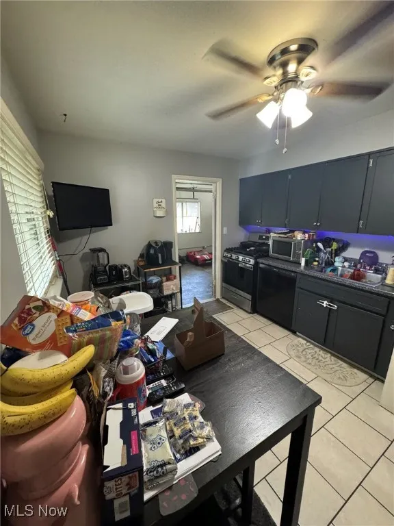 Dining area with light tile patterned floors and a ceiling fan