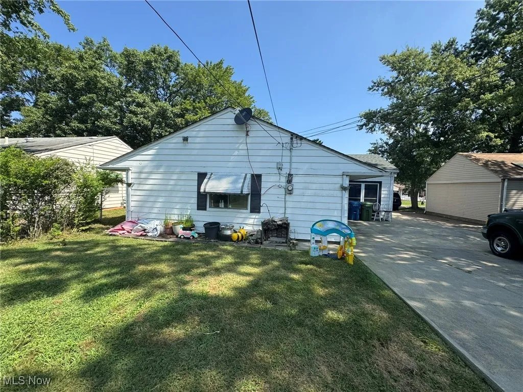 Rear view of property featuring a lawn