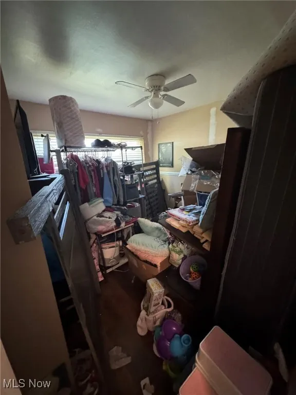 Bedroom with ceiling fan and dark wood finished floors
