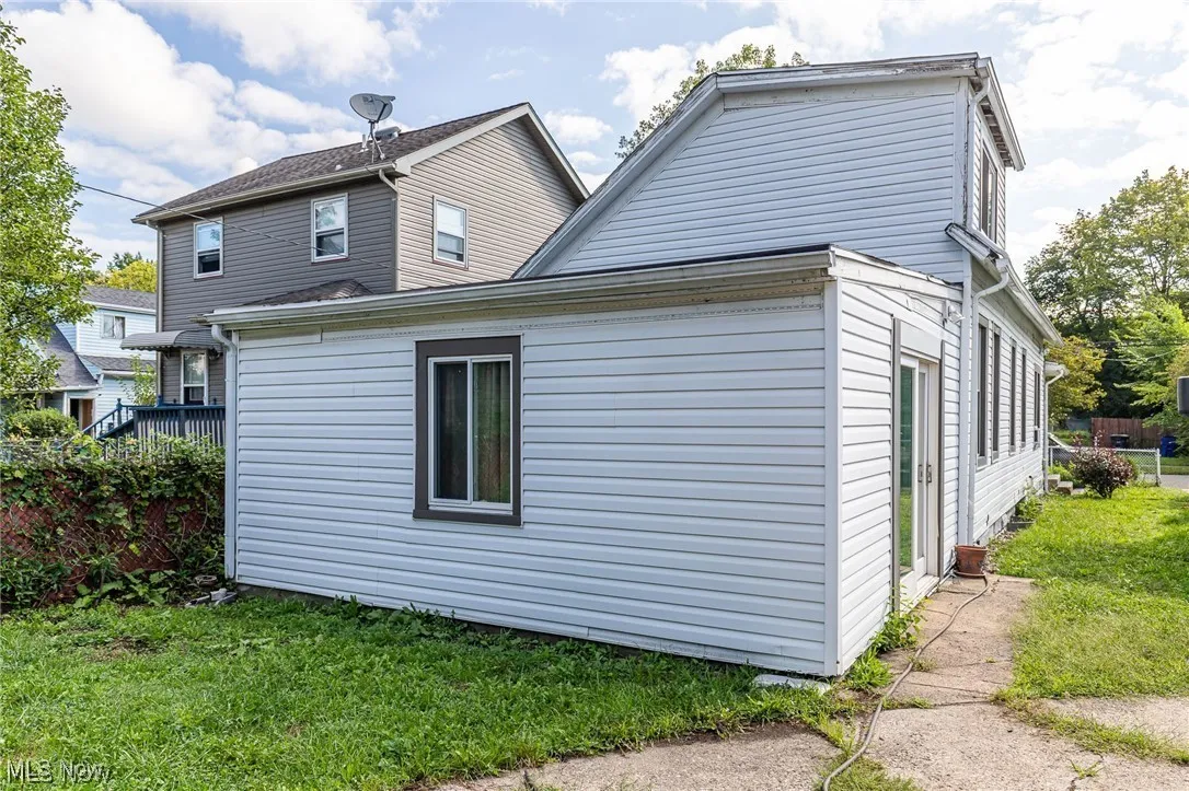 View of property exterior with a lawn