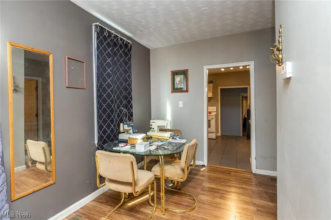 Dining room with wood finished floors and a textured ceiling