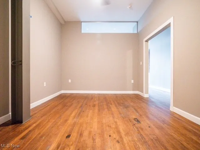 Unfurnished room featuring light wood-style flooring and baseboards