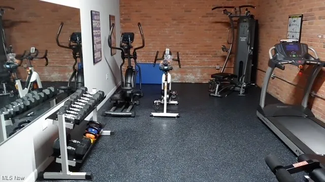 Gym featuring brick wall