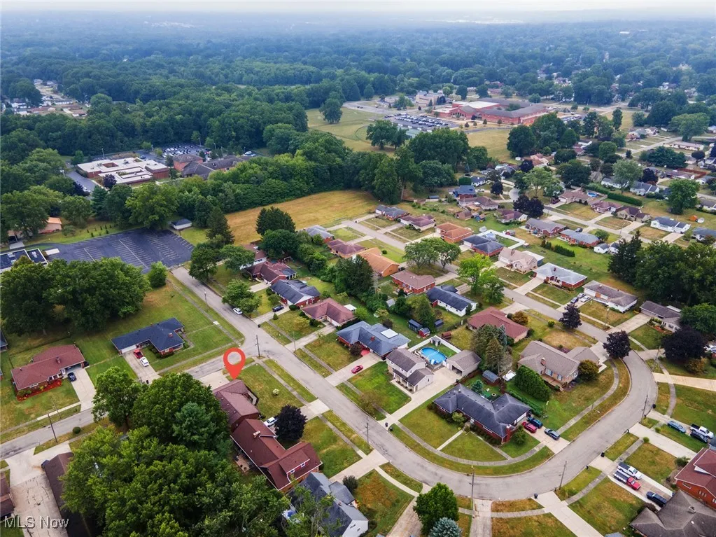 Aerial view of property's location with nearby suburban area