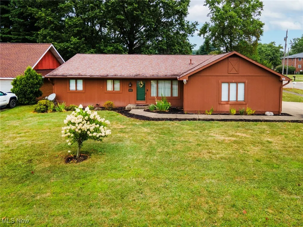 Single story home featuring a front lawn