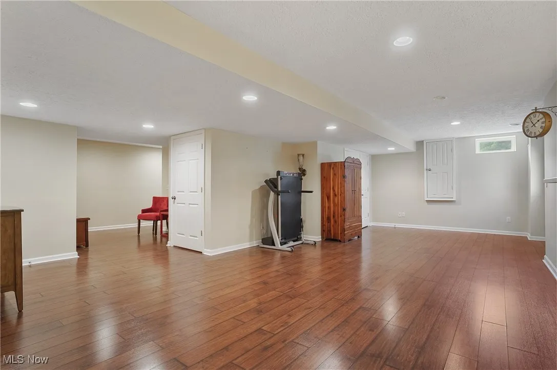 Unfurnished living room featuring a textured ceiling, hardwood / wood-style floors, and recessed lighting