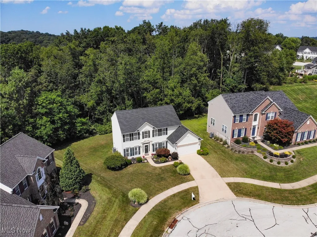 View of subject property featuring a heavily wooded area