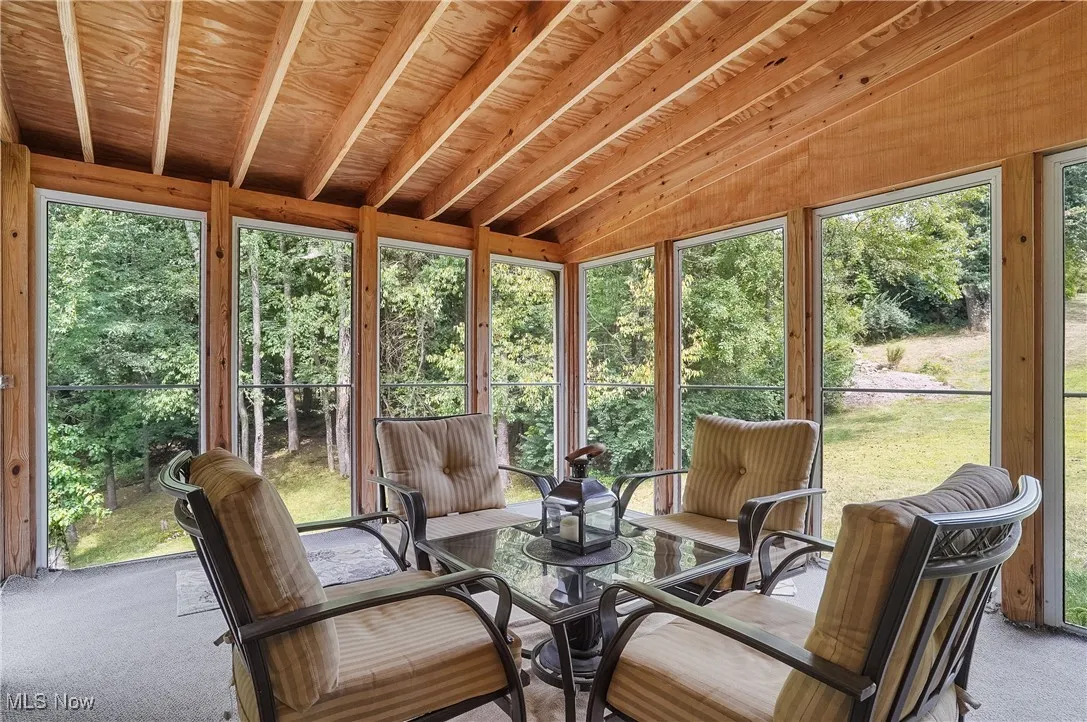 Sunroom / solarium featuring vaulted ceiling