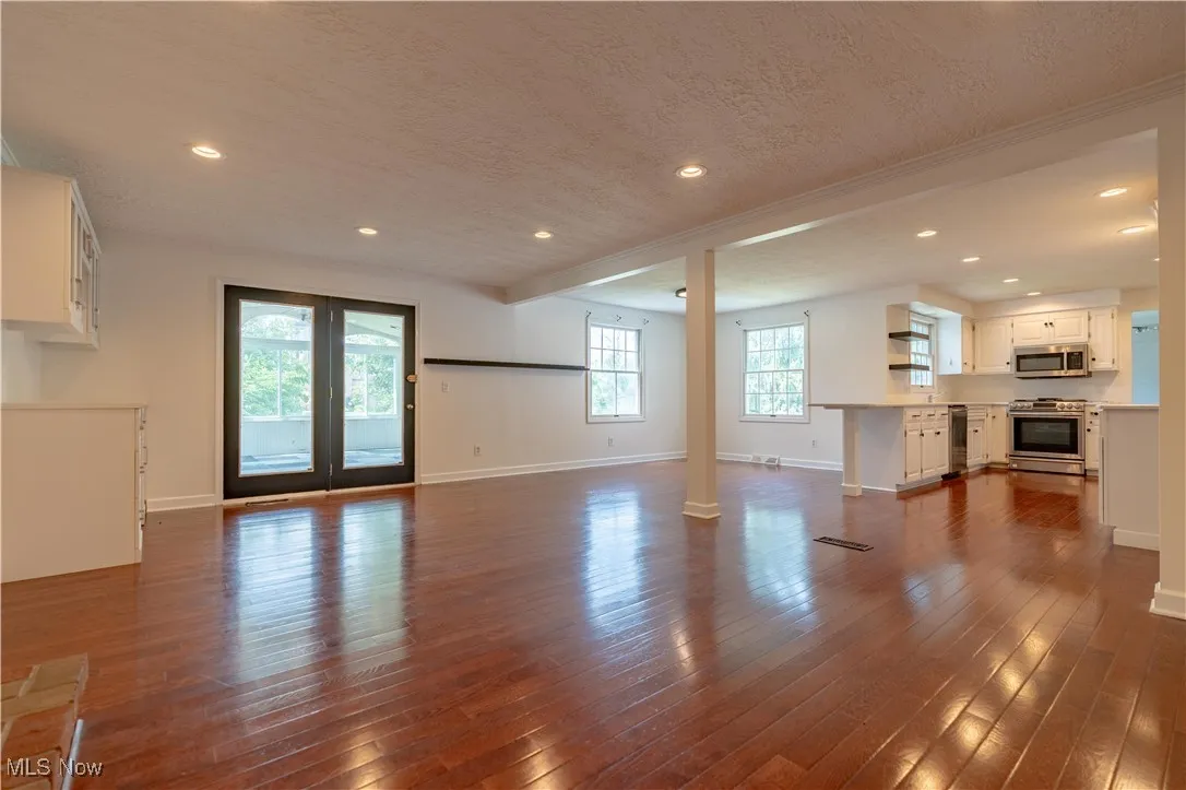 Family room open to the kitchen and doors leading to the sunroom
