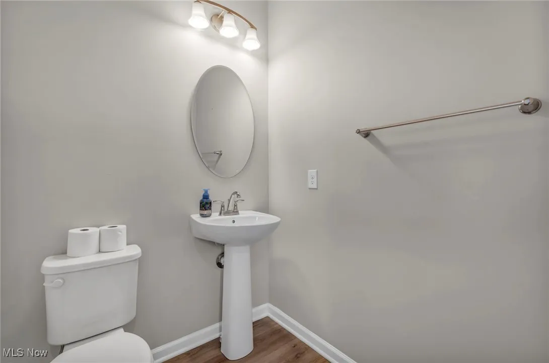 Bathroom featuring baseboards and wood finished floors