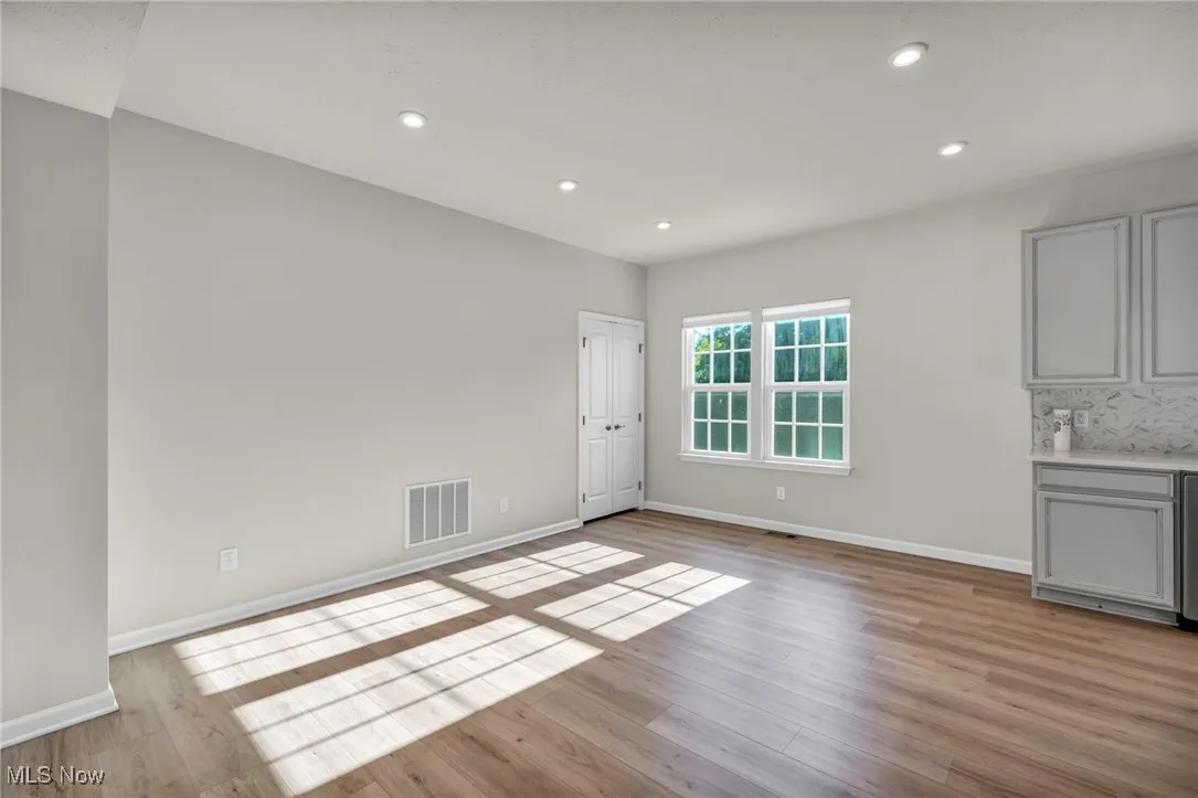 Unfurnished dining area featuring light wood finished floors and recessed lighting
