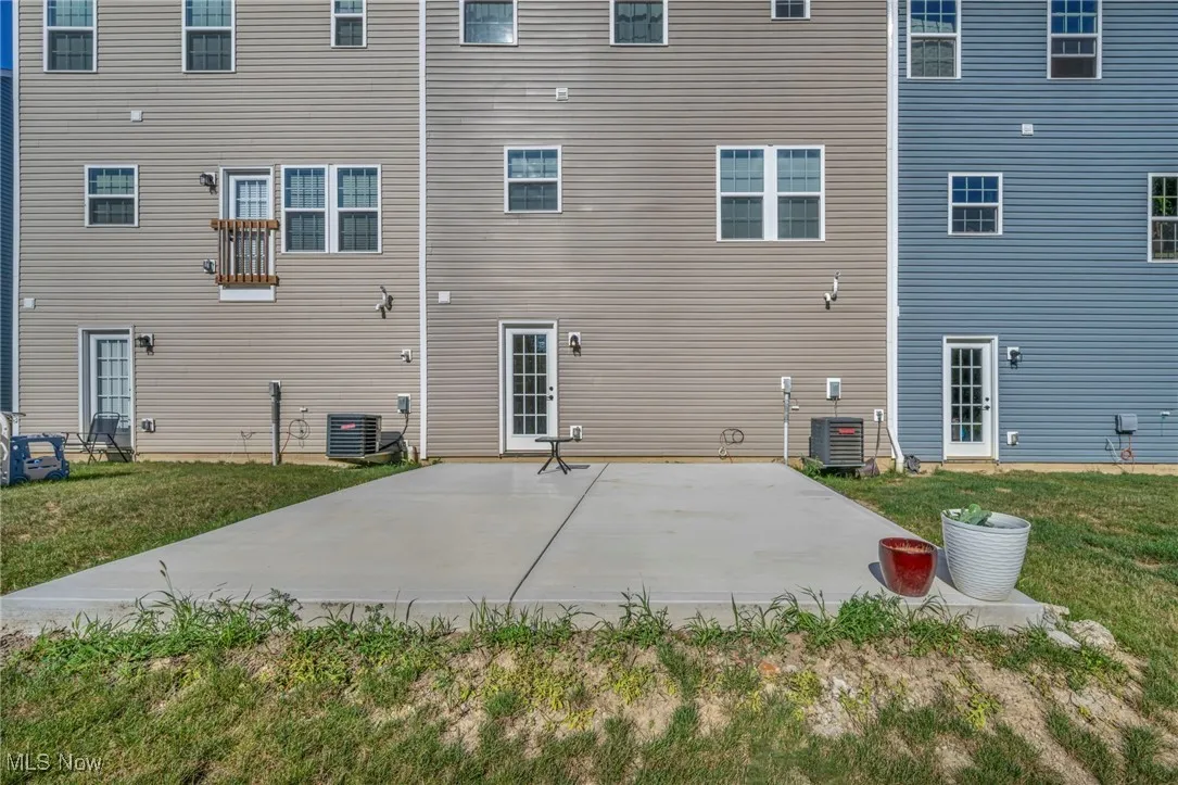 Back of property featuring a yard and a patio
