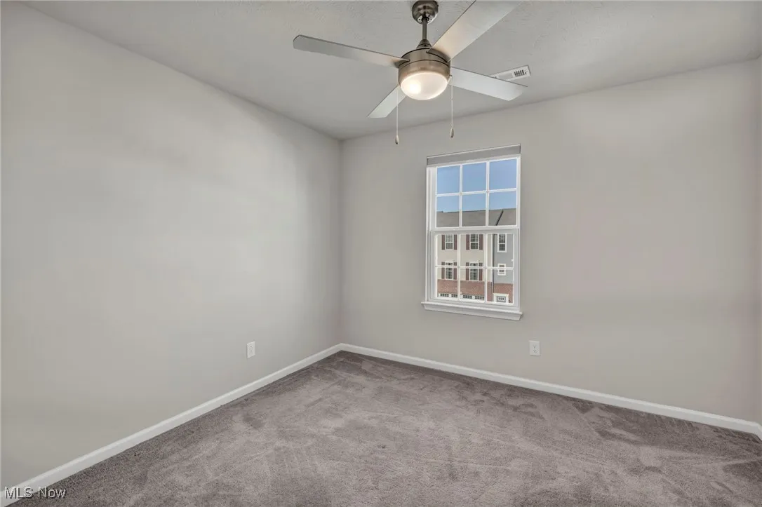 Spare room featuring carpet floors and baseboards