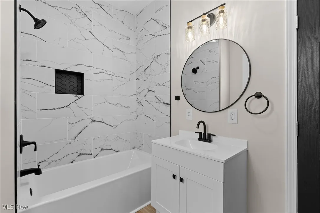 Full bathroom featuring shower / bathtub combination and vanity