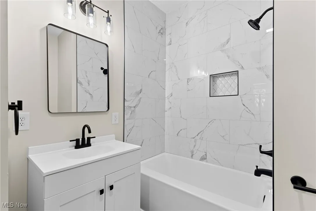 Bathroom with shower / bath combination and vanity