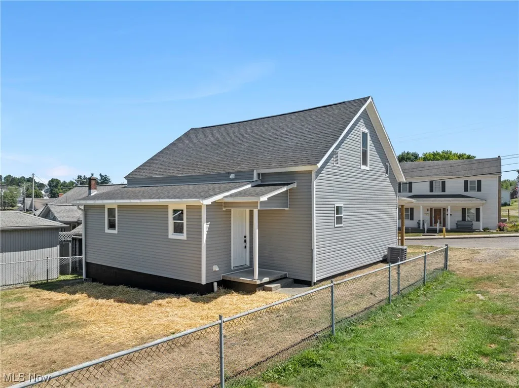 View of front of property featuring roof with shingles