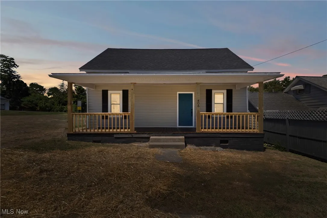 Bungalow-style house with a porch, a shingled roof, a front yard, and crawl space