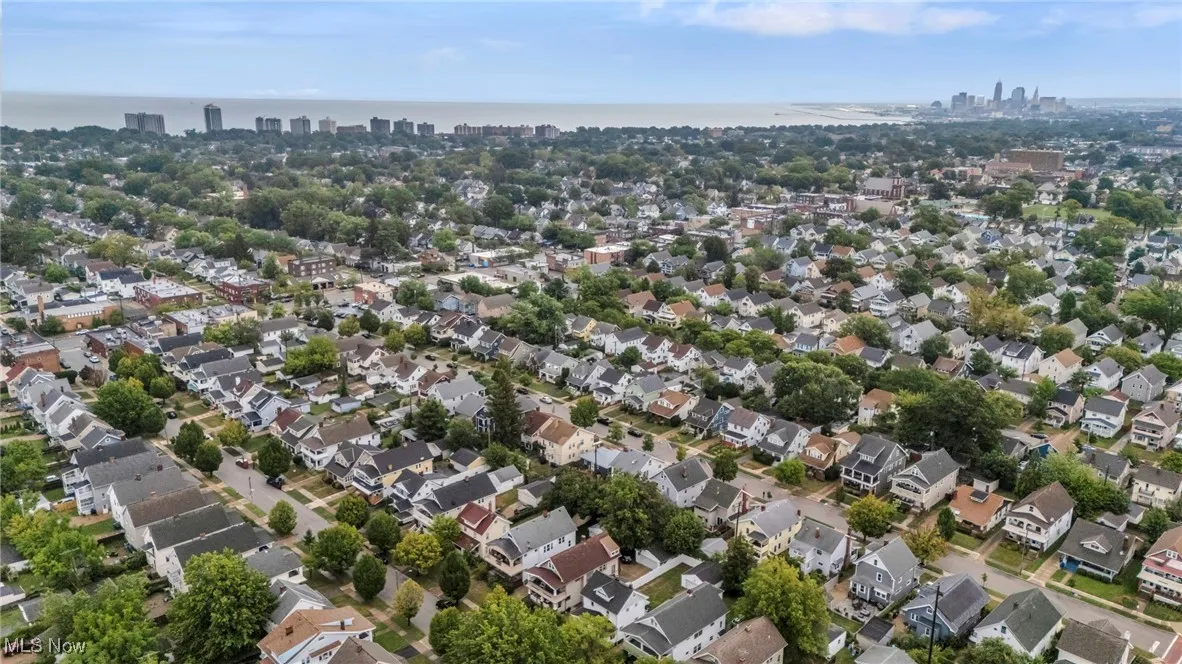 Aerial overview of property's location with city skyline and nearby suburban area