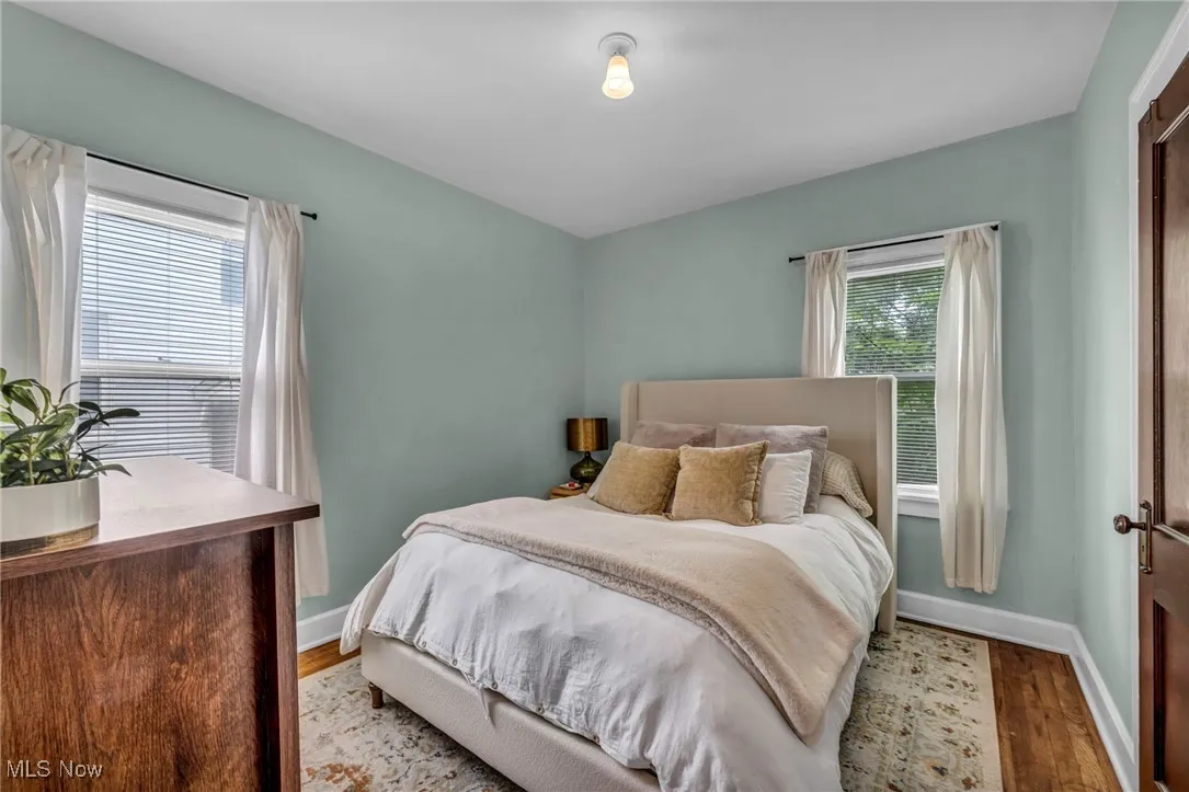 Bedroom with light wood-style floors and baseboards