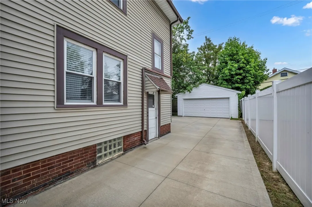 View of home's exterior with a detached garage and an outdoor structure