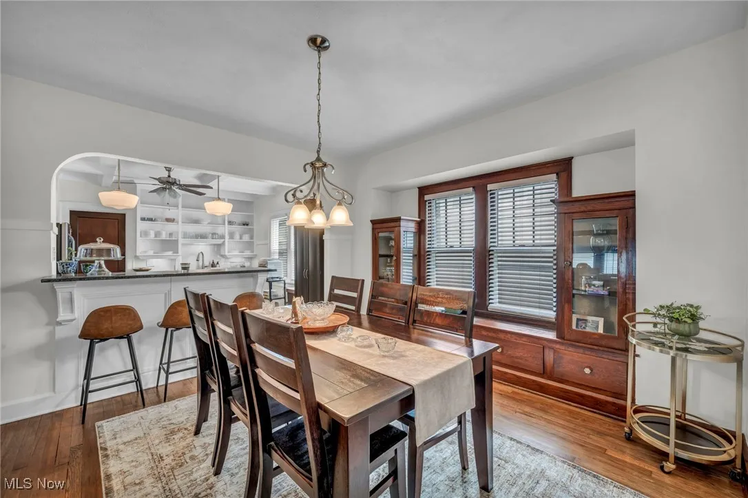 Dining area featuring ceiling fan and dark wood-type flooring
