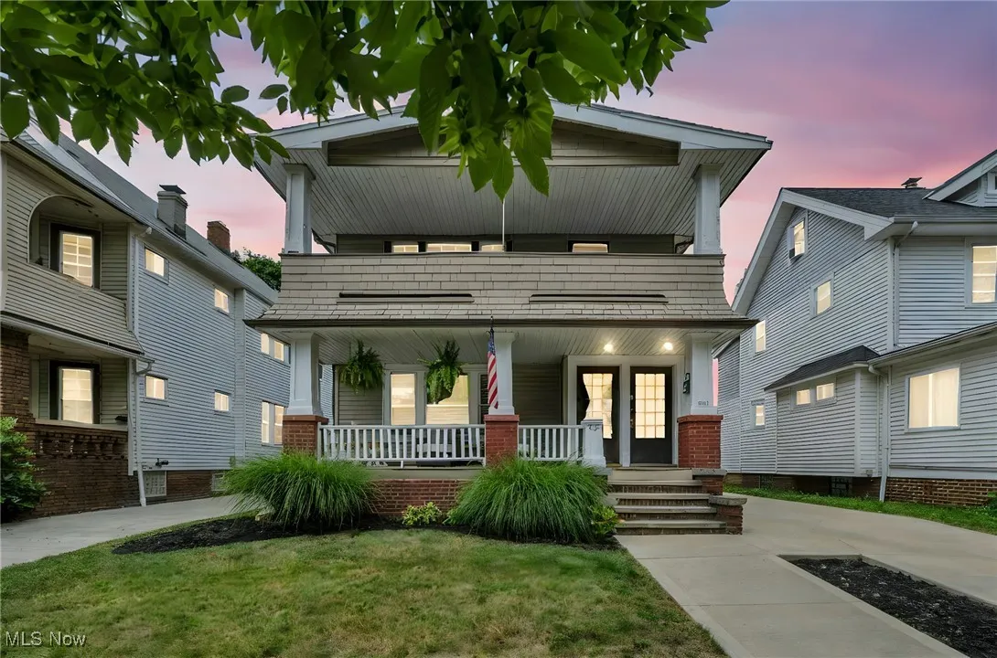 View of front of house featuring covered porch and a yard