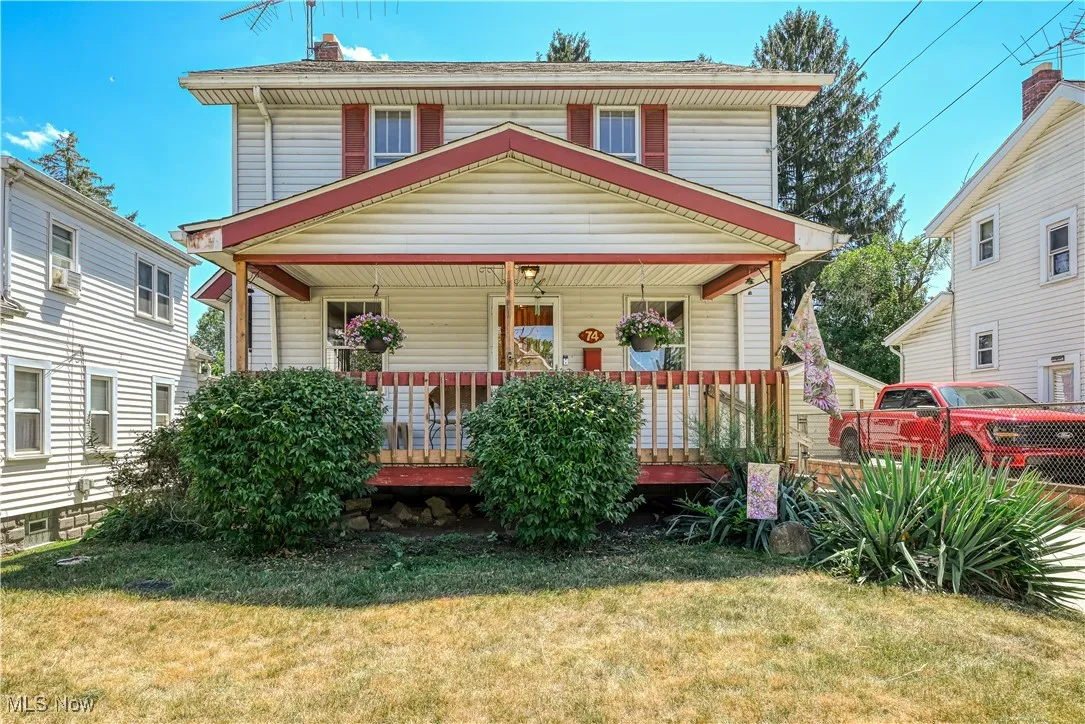 Traditional style home featuring a porch and front​​‌​​​​‌​​‌‌​‌‌​​​‌‌​‌​‌​‌​​​‌​​ lawn