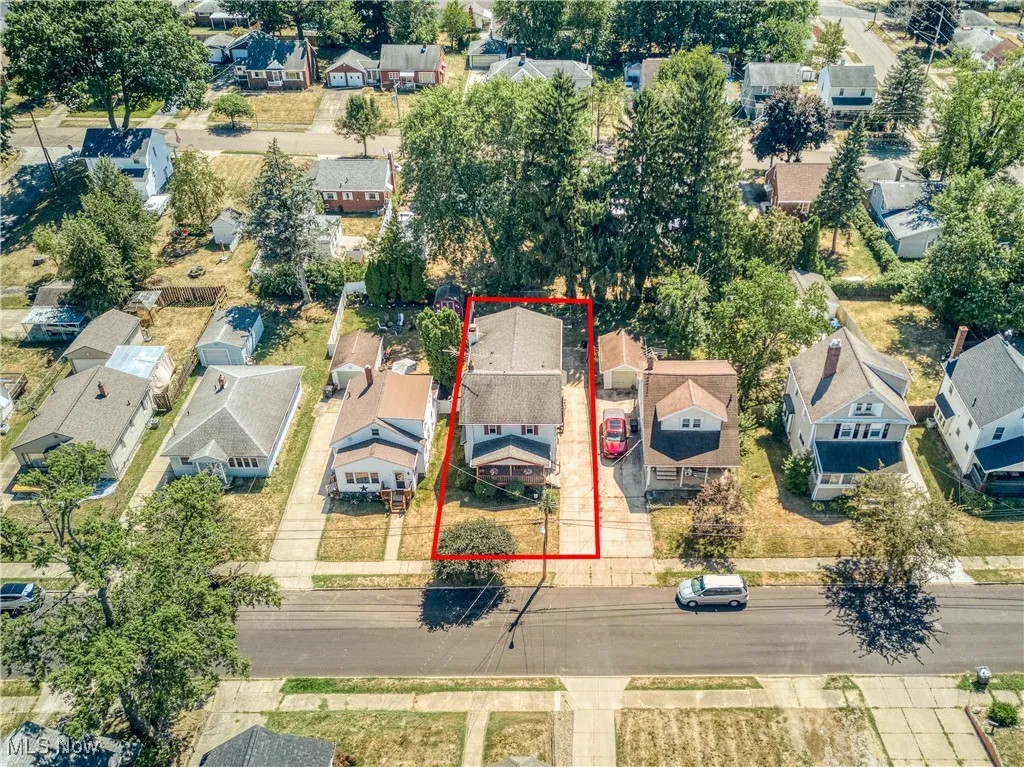 Aerial view of residential area with property parcel outlined