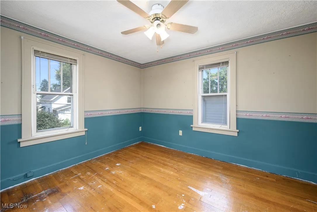 Bedroom featuring wood flooring, a ceiling fan, and a textured ceiling