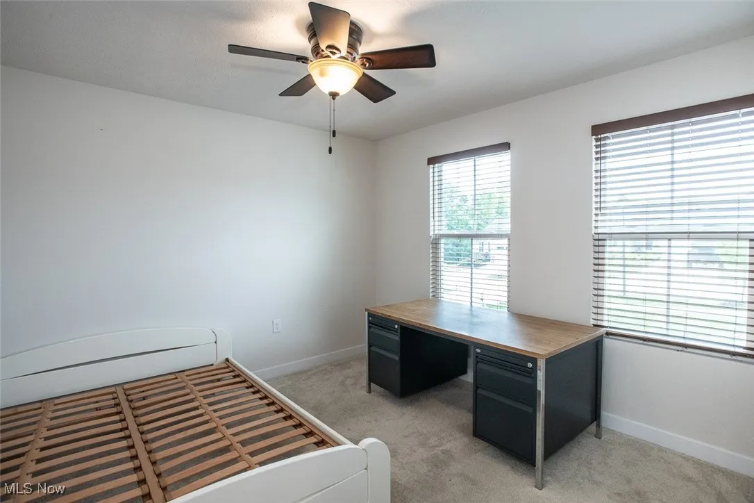 3rd bedroom with great natural light, a ceiling fan and custom blinds