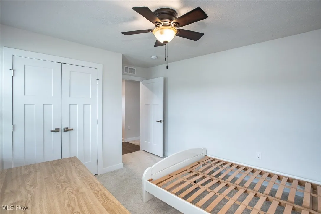 3rd bedroom with large closet and a ceiling fan