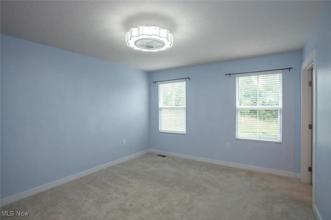 Plenty of natural light, ceiling fan and custom blinds.