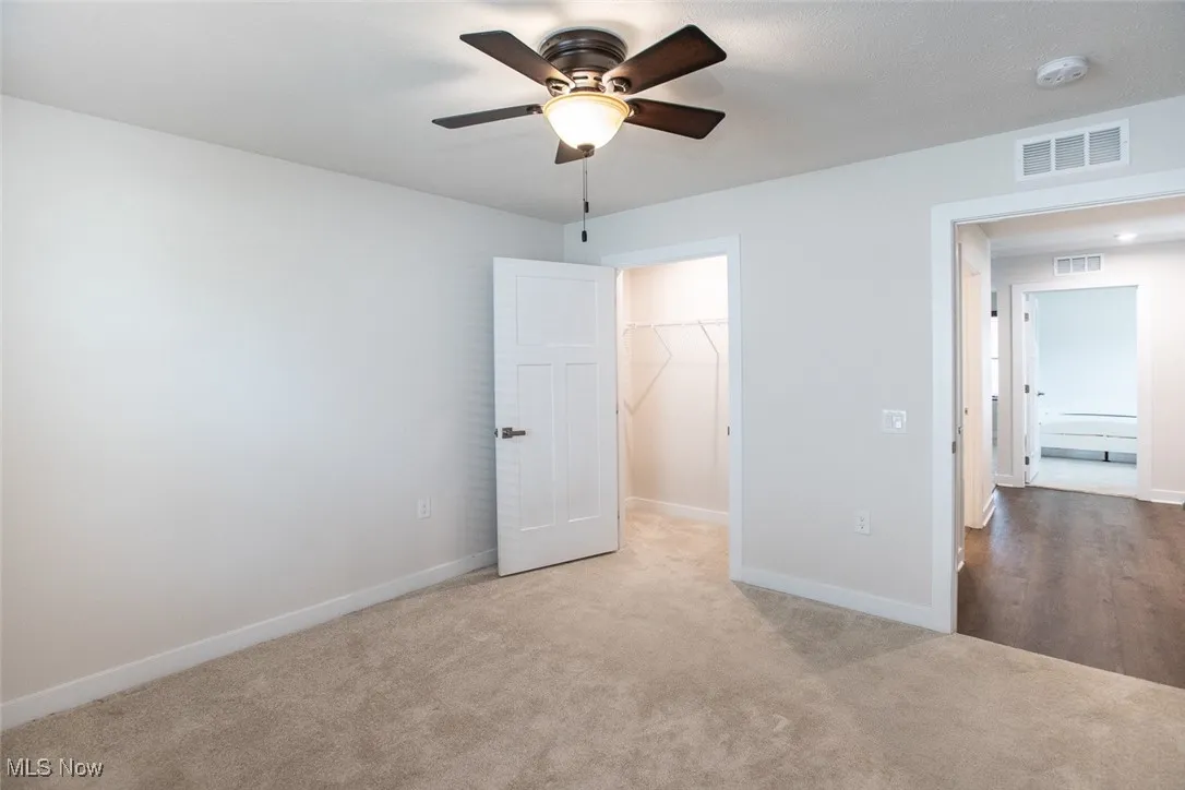 Bedroom 2 with walk in closet and ceiling fan