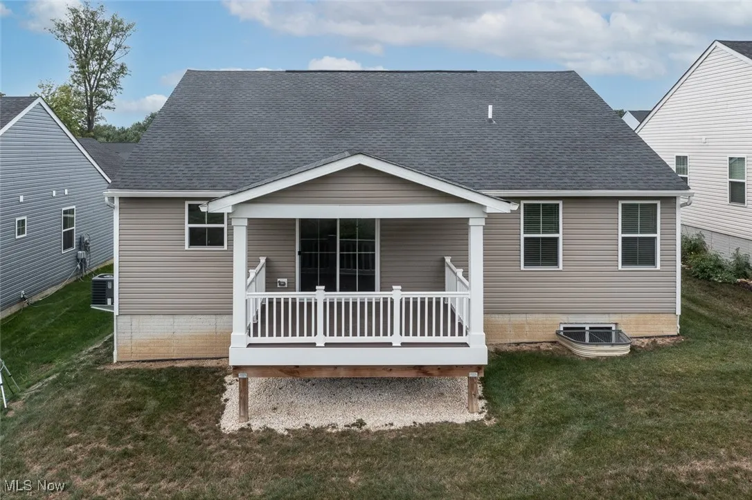 Covered composite deck and view of egress window for the basement.