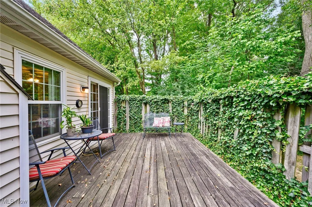 Wooden terrace featuring view of scattered trees