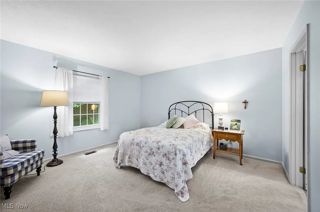 Bedroom with carpet floors and baseboards